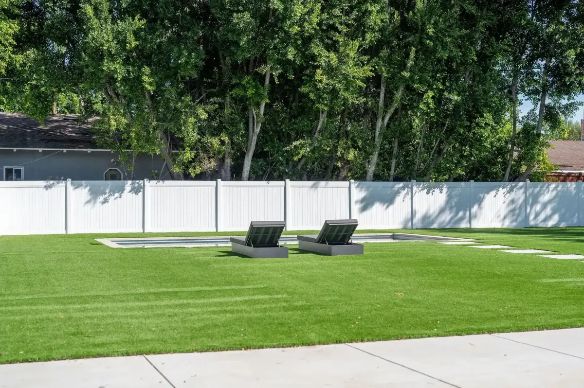 White vinyl fence installation at a residential property
