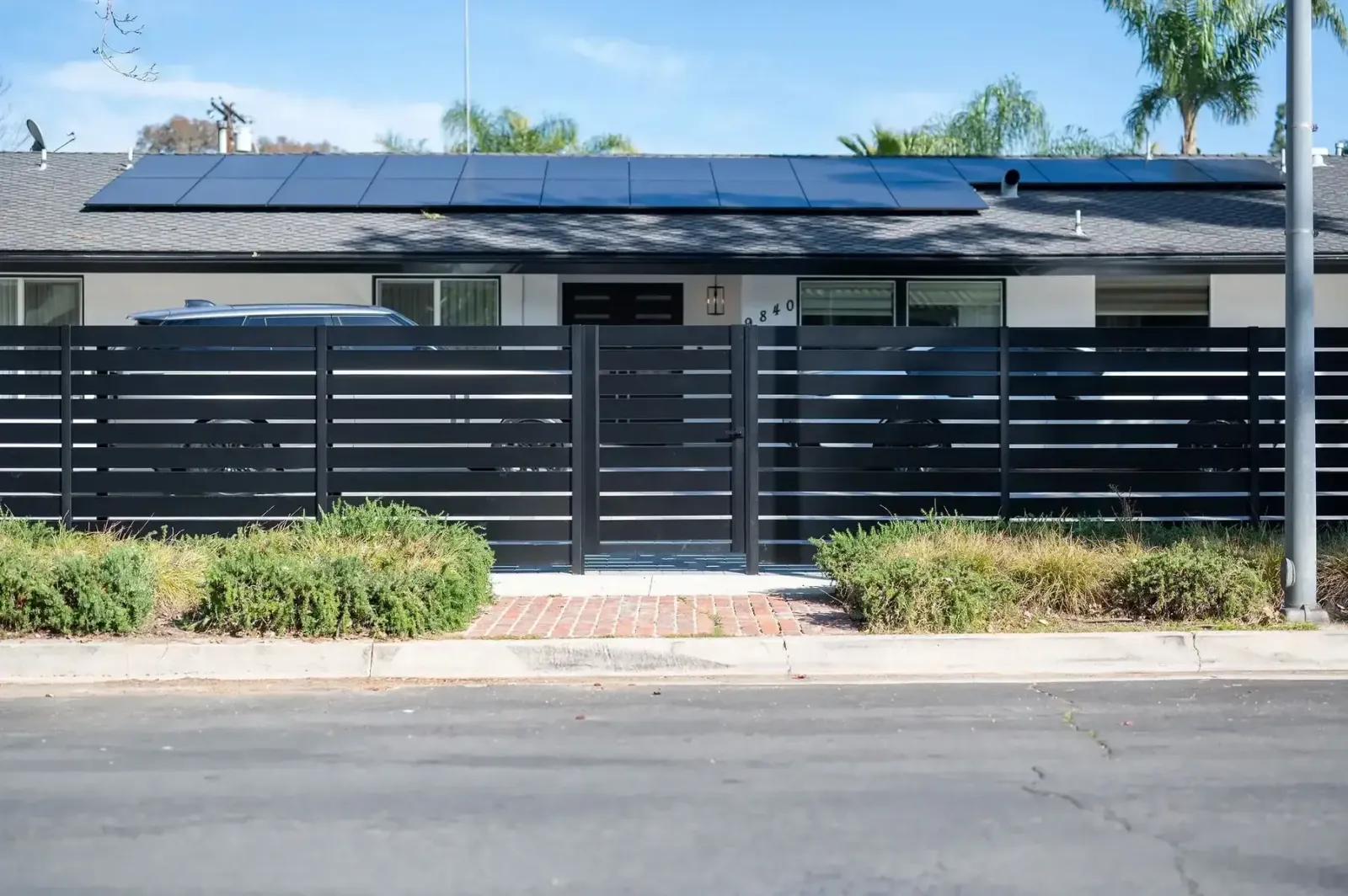Black aluminum wall topper installation in Sherman Oaks