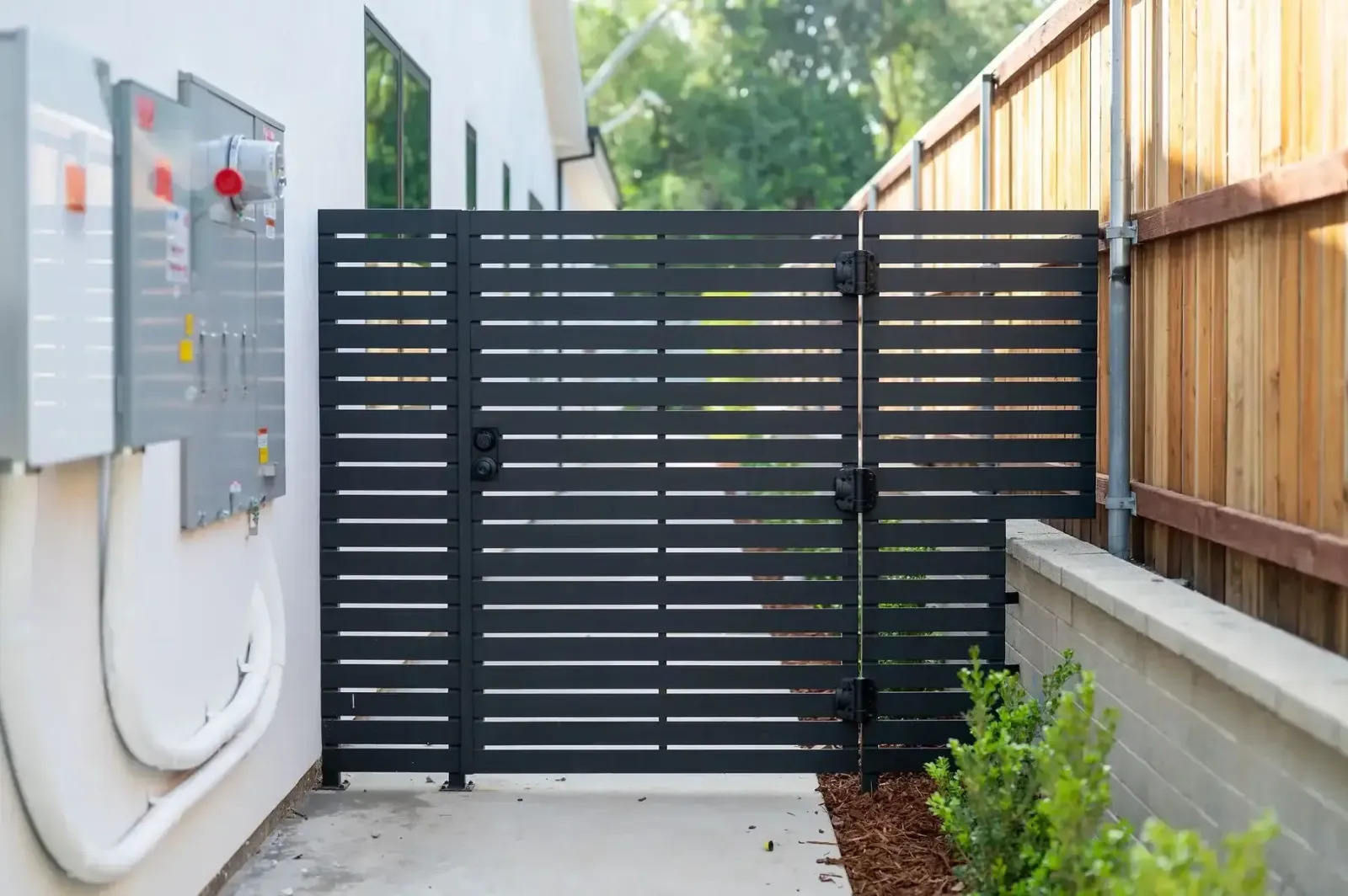 Black aluminum wall topper fence installation